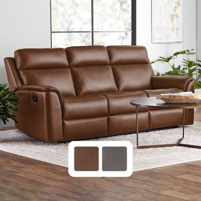 Premium Photo  A brown leather couch with a foot rest sits in front of