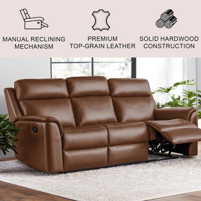 Premium Photo  A brown leather couch with a foot rest sits in front of