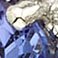 Tanzanite, variant on Round Cut 3 Stone Gemstone and 0.19 CT. T.W. Halo Diamond Ring in 14K Gold