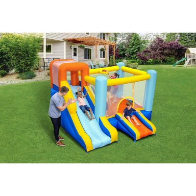 bounce house with slide and basketball hoop